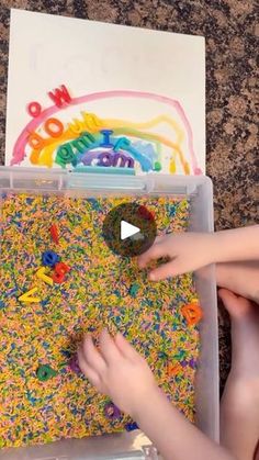 a child is playing with letters and numbers in a box