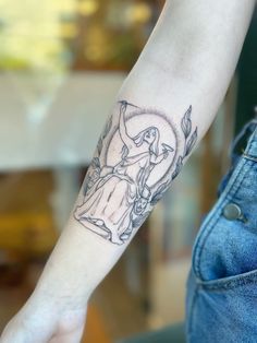 a woman's arm with a tattoo on it that has an image of the virgin mary