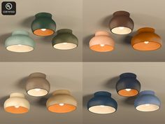 several different colored lights hanging from the ceiling in various shapes and sizes, with one light turned on