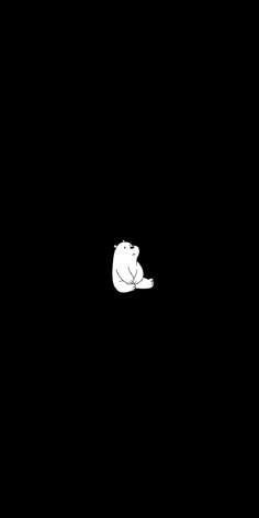 a white polar bear sitting on its back in the dark, looking up at something