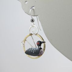 Feeling a little Loon-y? Then take a peek at these whimsical and wonderful Loon earrings that are artisan made, hand painted, and handcrafted in sterling silver, jeweler's brass and eclectica. They are a true pair, with each side facing the other (or away, depending on their mood) and measure just over 1.5 inches in length from the wire to the base and .75 inch wide. The Birds are in excellent, new condition and unmarked, although guaranteed to be the above mentioned material. A fun pair for a f Whimsical Hand Painted Dangle Jewelry, Whimsical Hand Painted Drop Earrings, Whimsical Hand Painted Silver Earrings, Whimsical Hand Painted Earrings For Gifts, Whimsical Hand Painted Enamel Jewelry, Duck Earrings, Peacock Ring, Spring Birds, Shorebirds