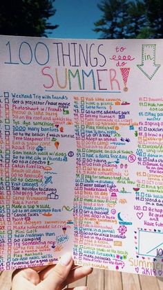 a hand holding up a sign that says 100 things to do in summer