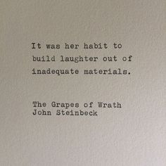 an old typewriter with the words it was her habit to build laughter out of landscape materials