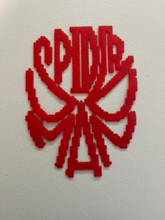 a red piece of art made out of legos on a white surface with the word sprite written in it