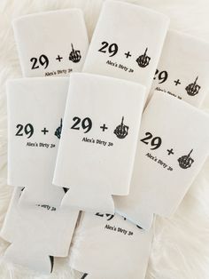 six white tea towels with black numbers on them