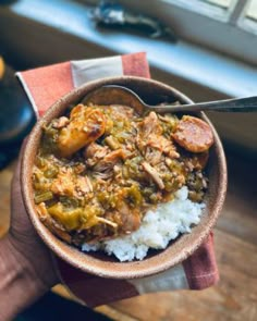 a person is holding a bowl of food