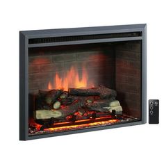 an electric fireplace with logs and flames on the side, next to a remote control