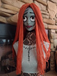 a creepy doll with long red hair and makeup