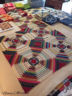 several quilts are laid out on a bed