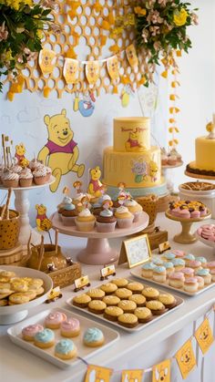 a winnie the pooh birthday party with cupcakes, cookies and desserts