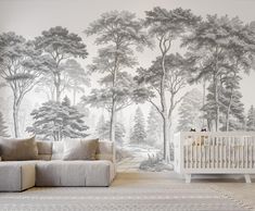 a baby's room with a large wall mural featuring trees and a white crib