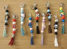 several different key chains with charms attached to them