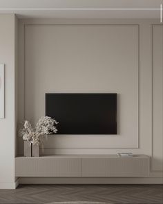 an empty living room with a flat screen tv on the wall and vases in front of it