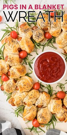 pigs in a blanket wreath with ketchup and cherry tomatoes on the side for dipping