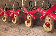 four wooden wine bottles decorated with red ribbon and reindeer noses