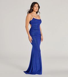 a woman in a blue dress posing for the camera