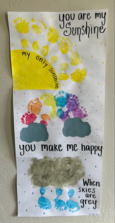 a paper sign that says you are my sunshine and two handprints on it