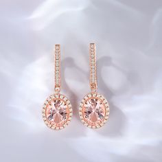 Elegance meets sophistication in this captivating design, where the lustrous morganite takes center stage, exuding a soft and enchanting hue. The halo of shimmering stones that surrounds it adds a touch of brilliance, creating a mesmerizing play of light and sparkle. These earrings are a testament to timeless beauty and impeccable craftsmanship. They effortlessly blend classic and contemporary styles, making them the perfect accessory for any occasion. Whether you're attending a glamorous soirée Morganite Halo Design Jewelry For Formal Occasions, Elegant Halo Rose Gold Earrings, Formal Morganite Halo Jewelry, Elegant Rose Gold Halo Earrings, Elegant Oval Rose Gold Earrings, Elegant Morganite Halo Jewelry, Elegant Morganite Jewelry With Halo, Elegant Blush Earrings, Elegant Morganite Jewelry