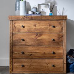 a wooden dresser sitting next to a wall