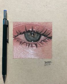 a drawing of an eye and a pen on top of a piece of white paper