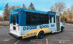 a blue and white bus parked in a parking lot