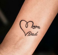 a woman's arm with a tattoo that says mom and dad on the wrist