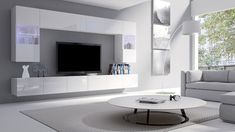 a modern living room with white furniture and large windows