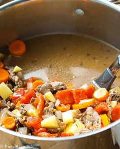 a pot filled with meat and vegetables on top of a stove