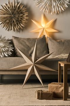 a living room scene with focus on the star decoration above the couch and coffee table