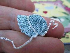 a small crocheted object being held in someone's hand