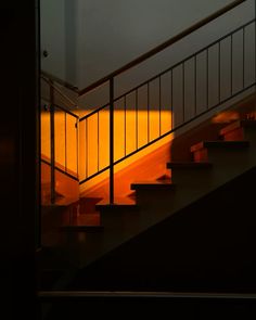 the stairs are lit up with yellow light