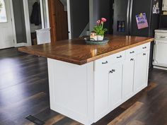 a kitchen island with a bowl of flowers on it