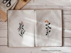 two embroidered napkins with flowers on them