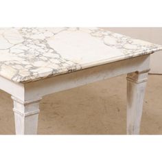 a white table with marble top and legs