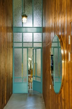 a dog is standing in the doorway of a house with wood paneling on the walls