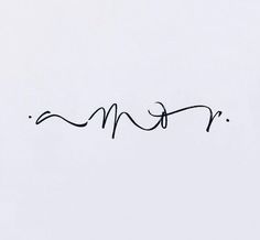 the word mom written in cursive writing on a white paper with black ink