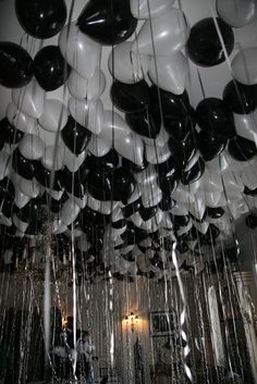 black and white balloons hanging from the ceiling