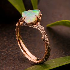 A handmade twig ring set with a top quality, natural Australian opal. The ring is made with any of the available metals you select. All of the metals we use are 100% recycled. --->The pictured ring is available in 18k rose gold. You can select any of the loose opals and I will make the ring with it. Pictured Opal Dimensions - 8X8.5X2.4 Weight - 1.2ct, 100% natural Australian opal 2700$ Opal #1 Dimensions - 7.9X10.6X2.8 Weight - 1.65ct, 100% natural Australian opal 3200$ Opal #2 Dimensions - 1 Uncut Opal Ring, Ethereal Opal Ring As Gift, Nature-inspired Opal Ring Gift, Unique Gold Adjustable Opal Ring, Twig Opal Ring, Nature-inspired Opal Gemstone Jewelry, Twig Ring, Australian Black Opal, Leather Ring