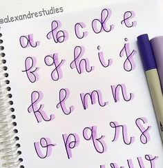 the letters and numbers are written in cursive writing on a notepad with a purple pen