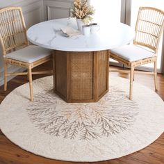 a round dining table with chairs around it