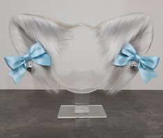 Grey and White cat ears. Light blue satin bows with silver bells, attached by hair clips. Ears and bows are Handmade. Size- Height 6 inches. Width 11 inches. These animal ears are only made from high quality faux fur. Wire lines the inside of the ears so they are able to bend and change shape to a certain degree. Ears are attached to the headband with wire and glue so placement on the headband is not adjustable. The bows are made from light blue satin ribbon and have silver bells. Bows are attac White Cat Ears, Gray And White Cat, Grey And White Cat, Cat Ear Headband, Silver Hair Clip, Metal Headbands, Metal Hair Clips, Silver Bells, Cat Ear