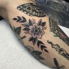 a close up of a person's arm with tattoos on it