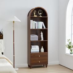 a bookcase in the corner of a room