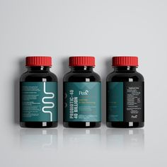 three bottles of vitamin supplements sitting on top of each other