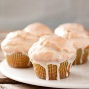 three cupcakes with frosting on a white plate