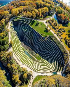 an aerial view of the serpent river amphite in autumn, with trees surrounding it