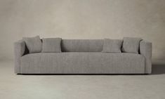 a gray couch sitting on top of a white floor