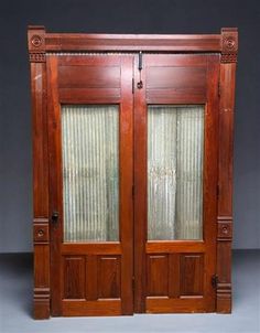 an old wooden double door with glass panels