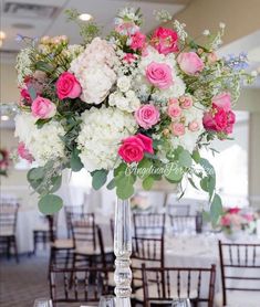 a vase filled with pink and white flowers on top of a table