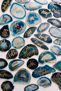 some blue and gold painted rocks with writing on them